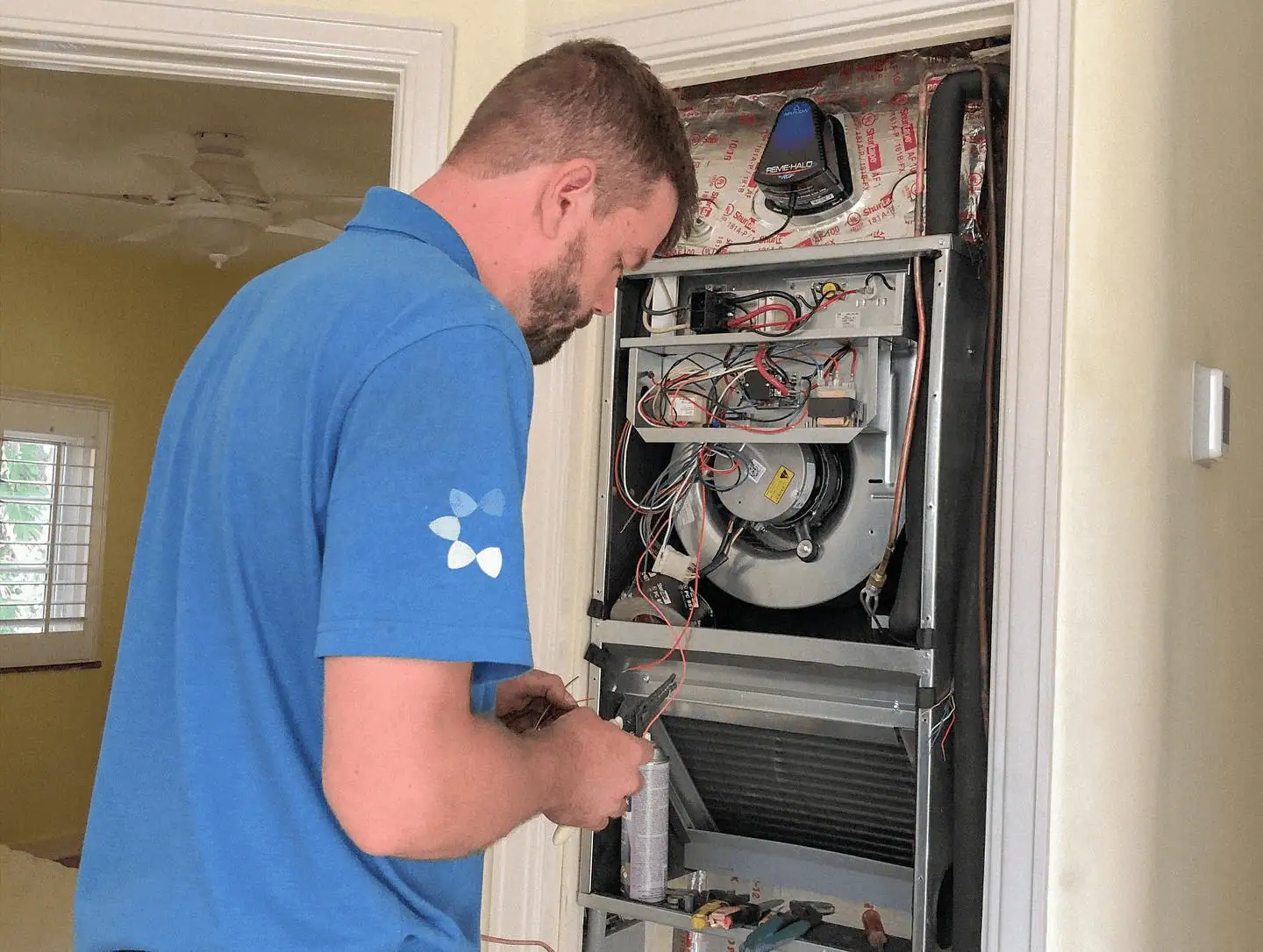 Comfort Authority technician servicing an air handler